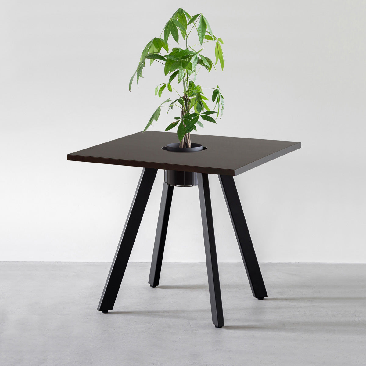 KANADEMONOのワイヤーバスケット付きのスクエアラバーウッド材ブラックブラウンカラー天板にマットブラックの4pinアイアン脚を組み合わせたカフェテーブル（バスケット使用例）