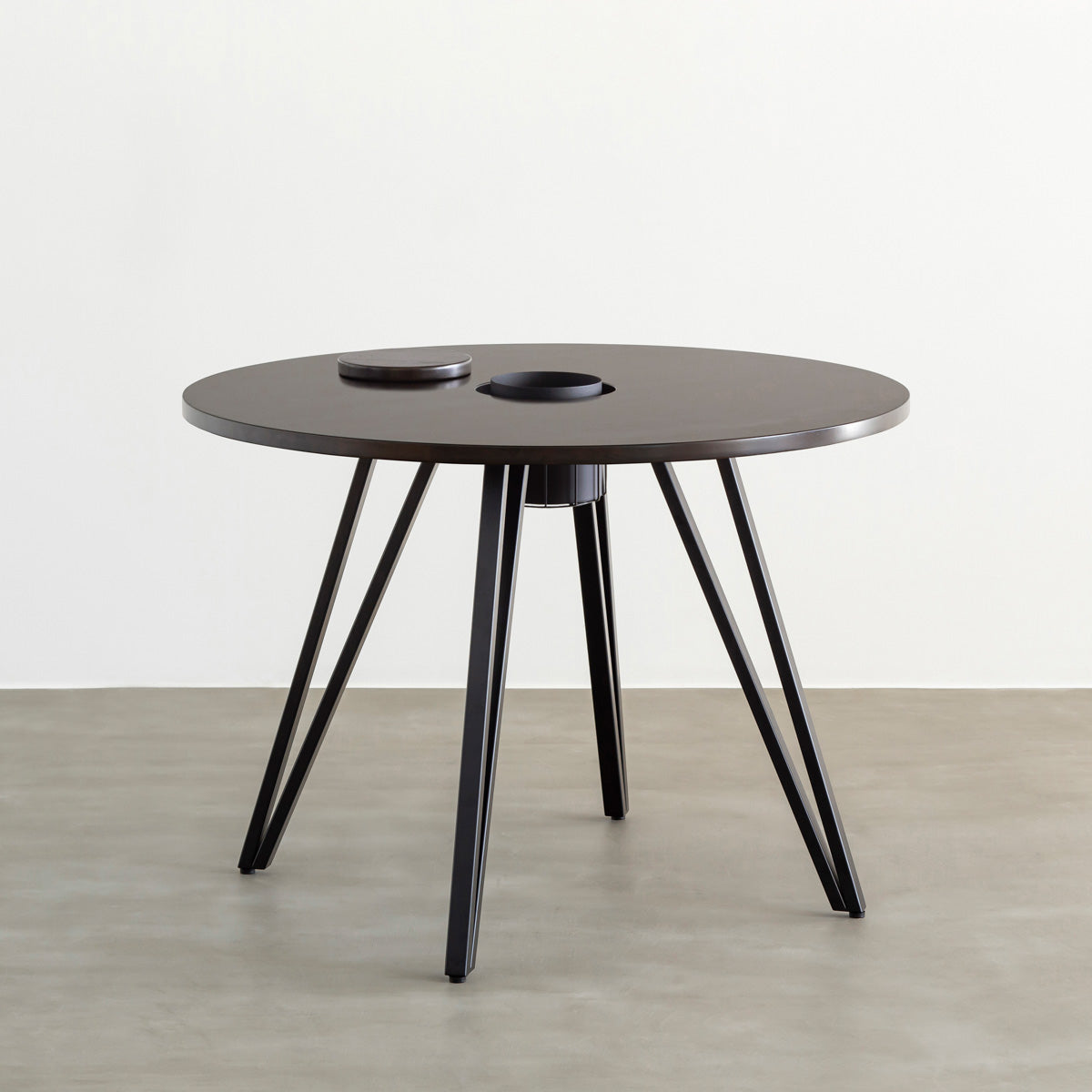 KANADEMONOのワイヤーバスケット付きのラバーウッド材ブラックブラウンのラウンド天板にマットブラックのトライアングル鉄脚を組み合わせたカフェテーブル