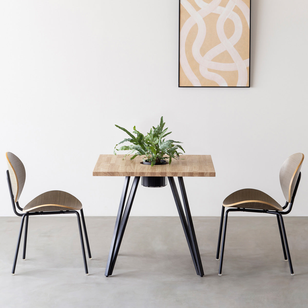 KANADEMONOのワイヤーバスケット付きのラバーウッド材アッシュグレーのスクエア天板にマットブラックのトライアングル鉄脚を組み合わせたカフェテーブル（使用例）