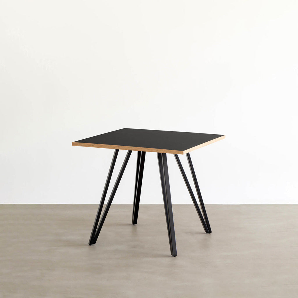 KANADEMONOのリノリウム・Neroのスクエア天板と三角のチューブが華やかなアイアン脚を組み合わせたカフェテーブル