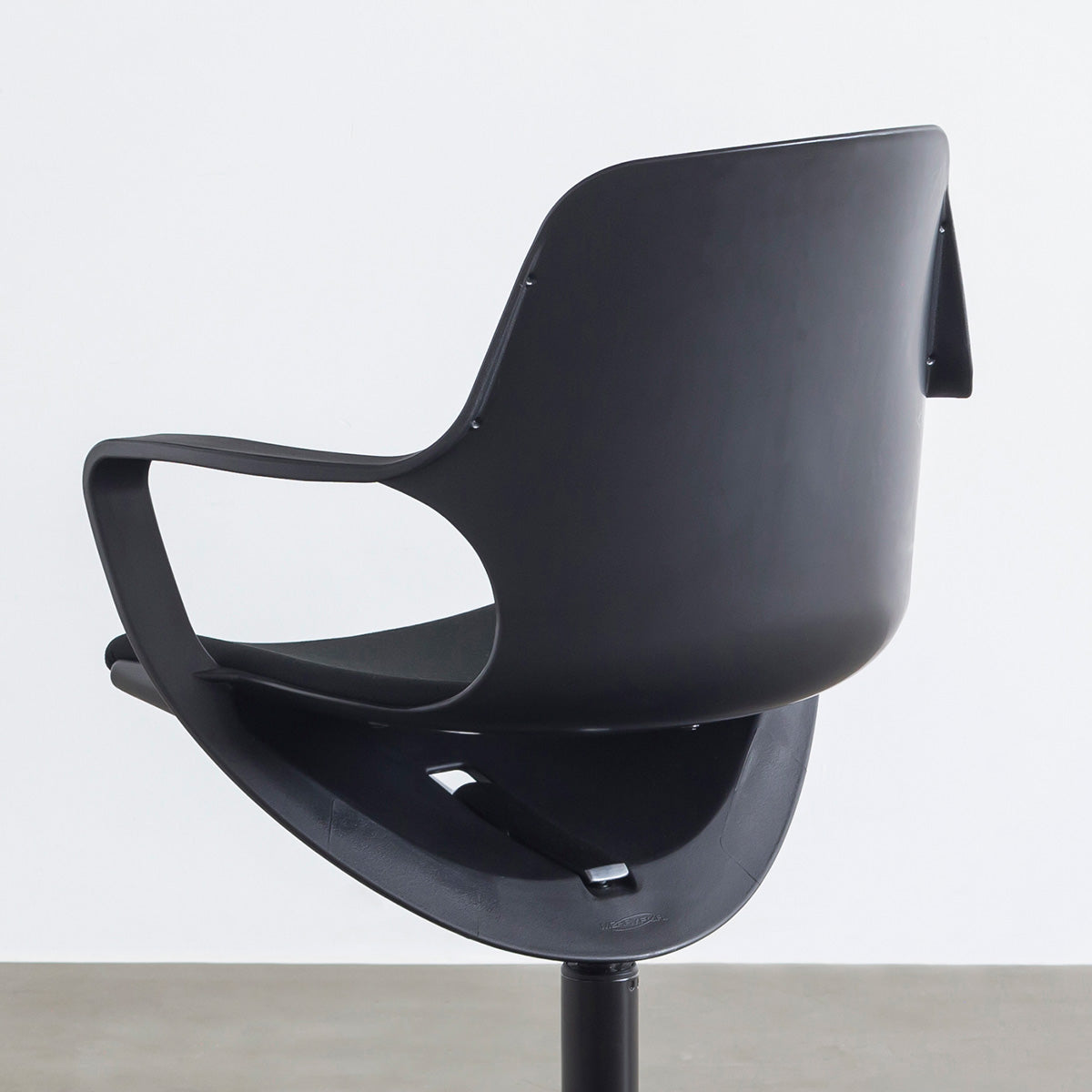 KANADEMONOの背もたれから座面までのなめらかなシルエットが特徴的なオールブラックの回転式デスクチェア(背面クローズアップ)