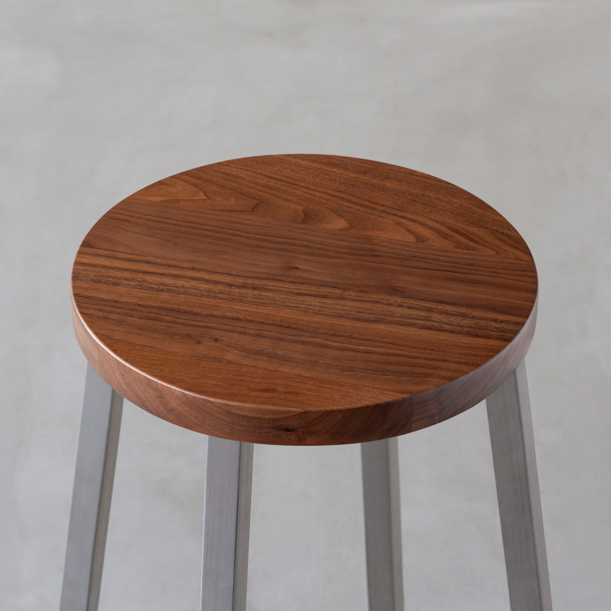 KANADEMONOの無垢ウォルナットRound座面とステンレスのSlant Bar脚を合わせたシンプルモダンなハイスツール（座面）