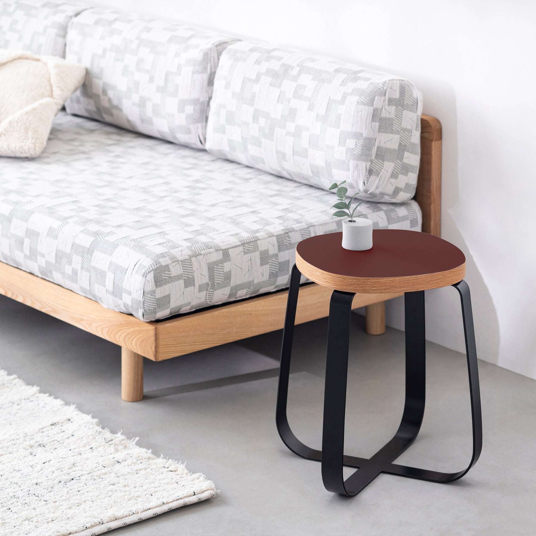 KanademonoのリノリウムBurgundy Squircle座面とブラックのCross Plate脚を合わせたシンプルモダンなスツール（使用例）