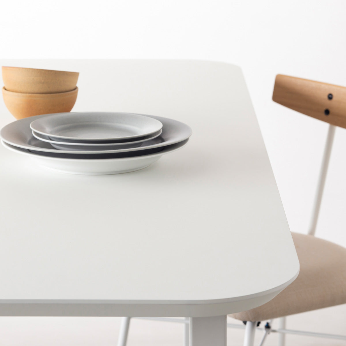 KanademonoのFENIX 天板ホワイトにマットブラックのスクエア鉄脚を組み合わせた、優れた性能と美しさを併せもつ新しいテーブル（ダイニング使用例2）